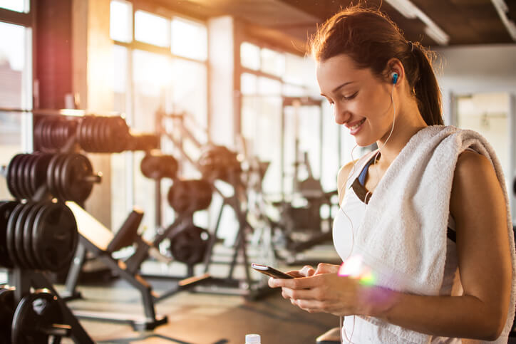 woman in gym with phone